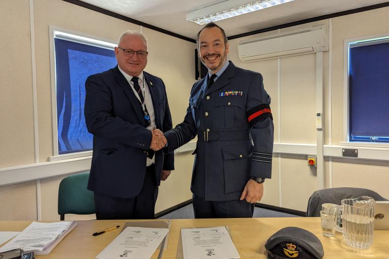 Councillor Ian Roome and Wing Commander Alex Drake sign the Armed Forces Covenant