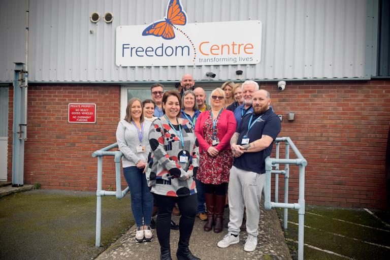 Housing team members in front of the Freedom Centre