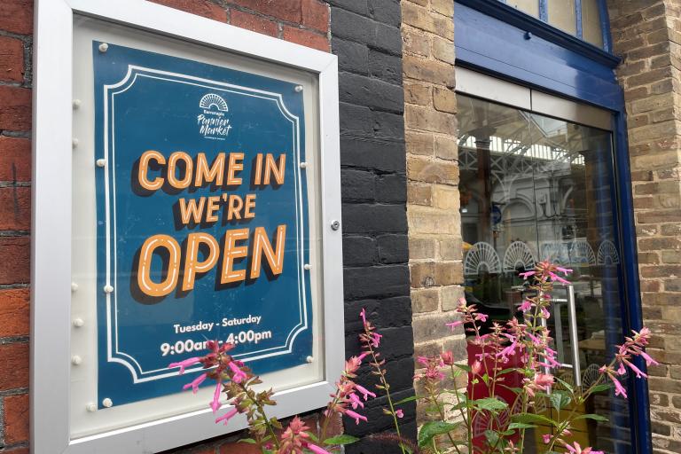 A Sign outside the Market saying "Come In We're Open"