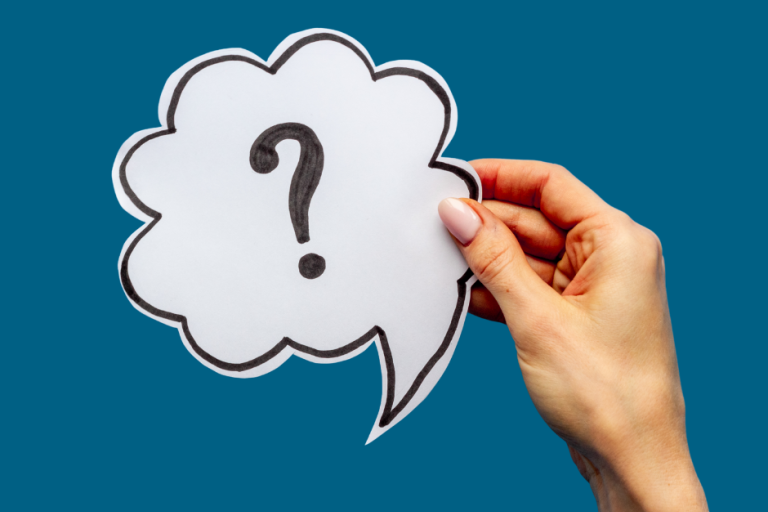 A hand holding a speech bubble with a question mark inside it