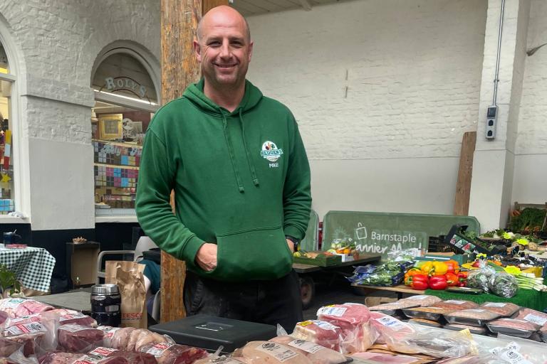 Man in a green jumper behind Heddens stand 