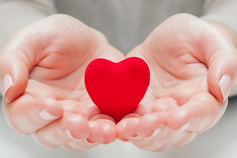 Hand holding a toy heart